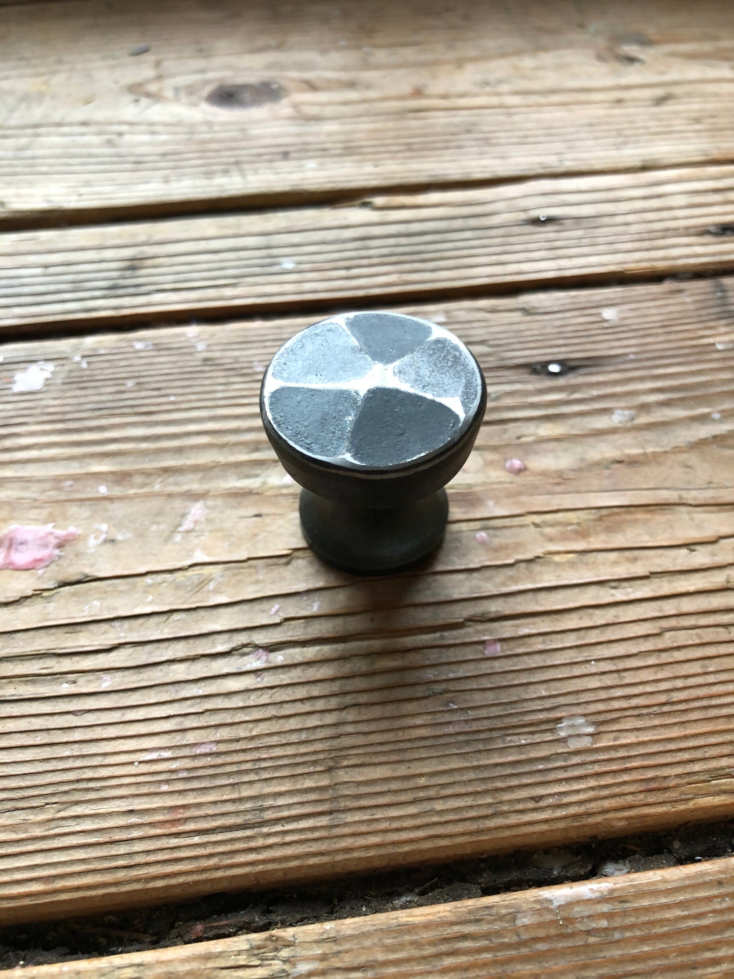 a cup of coffee sitting on a wooden bench 