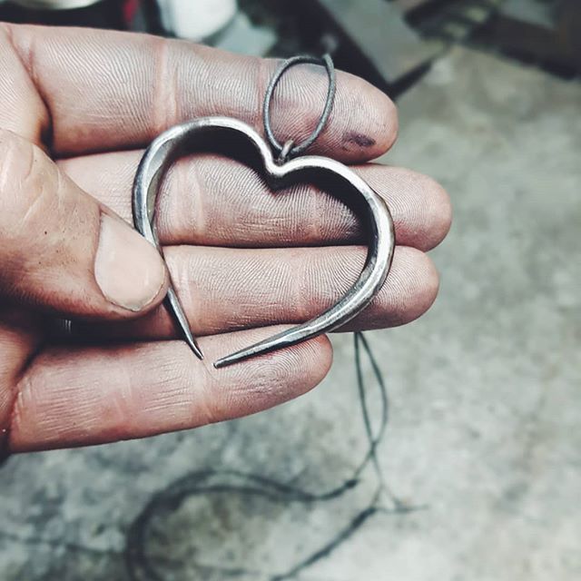 a person holding a pair of scissors in their hand