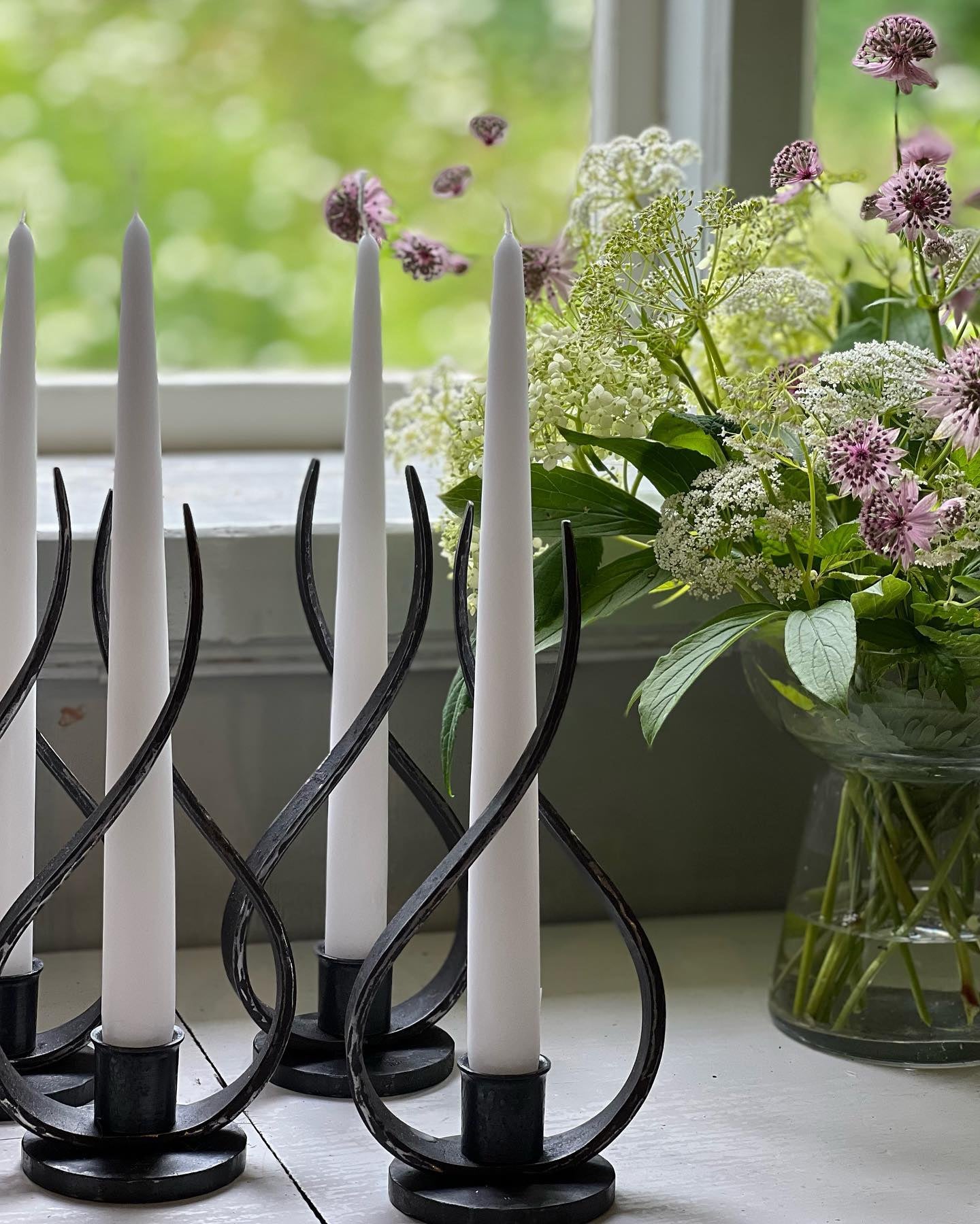 a glass vase with flowers on a table 