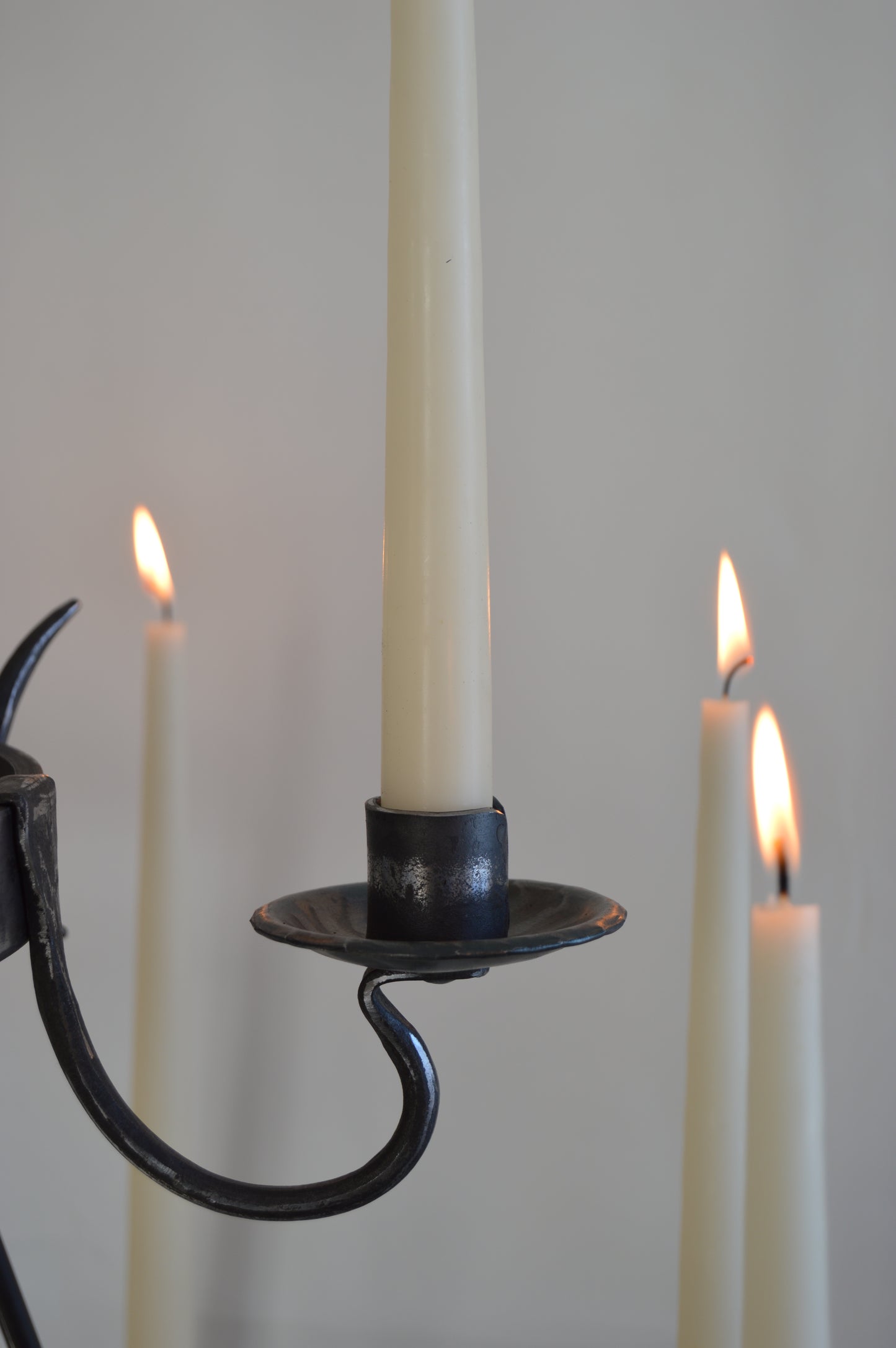 a lit candle sitting on top of a white table 