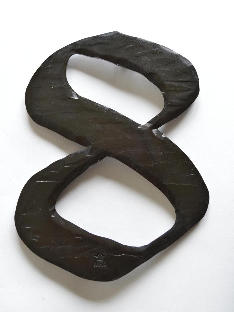 a pair of black scissors sitting on top of a white surface