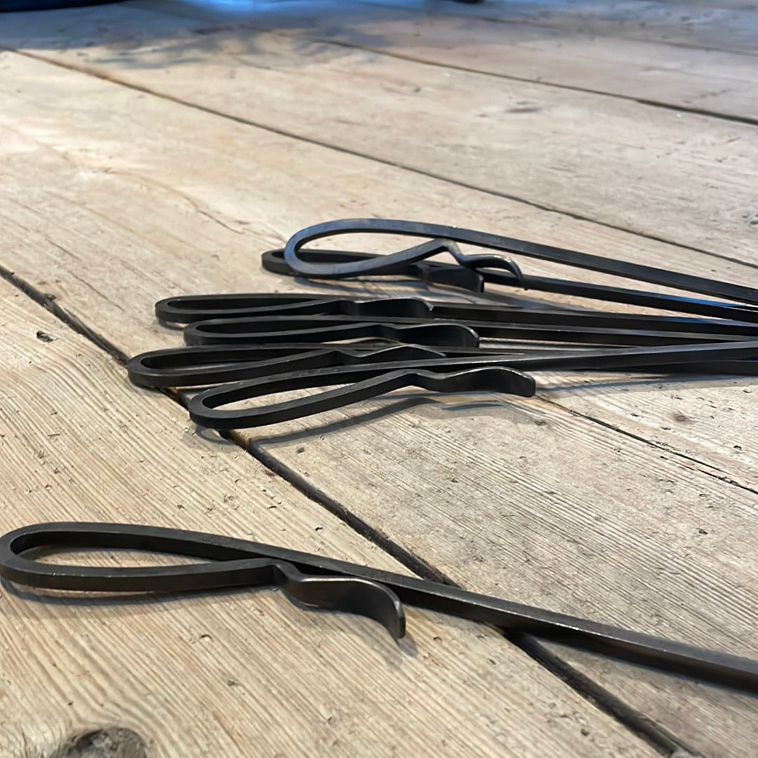 a pair of scissors on a wooden table 