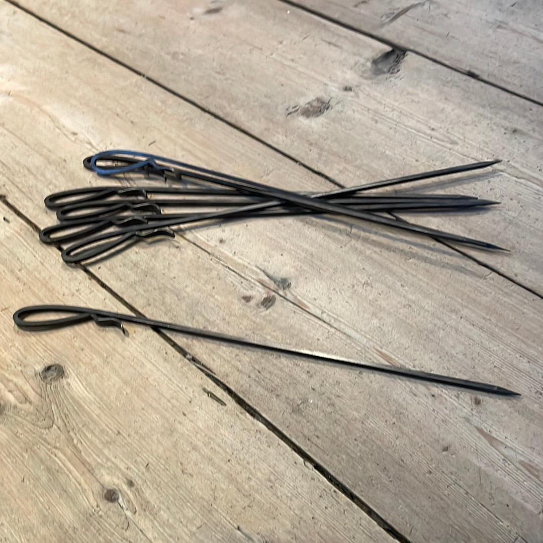 a fork and knife on a wooden table 