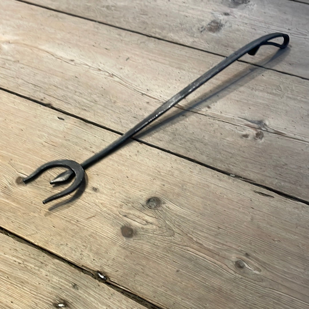 a pair of scissors sitting on top of a wooden bench 