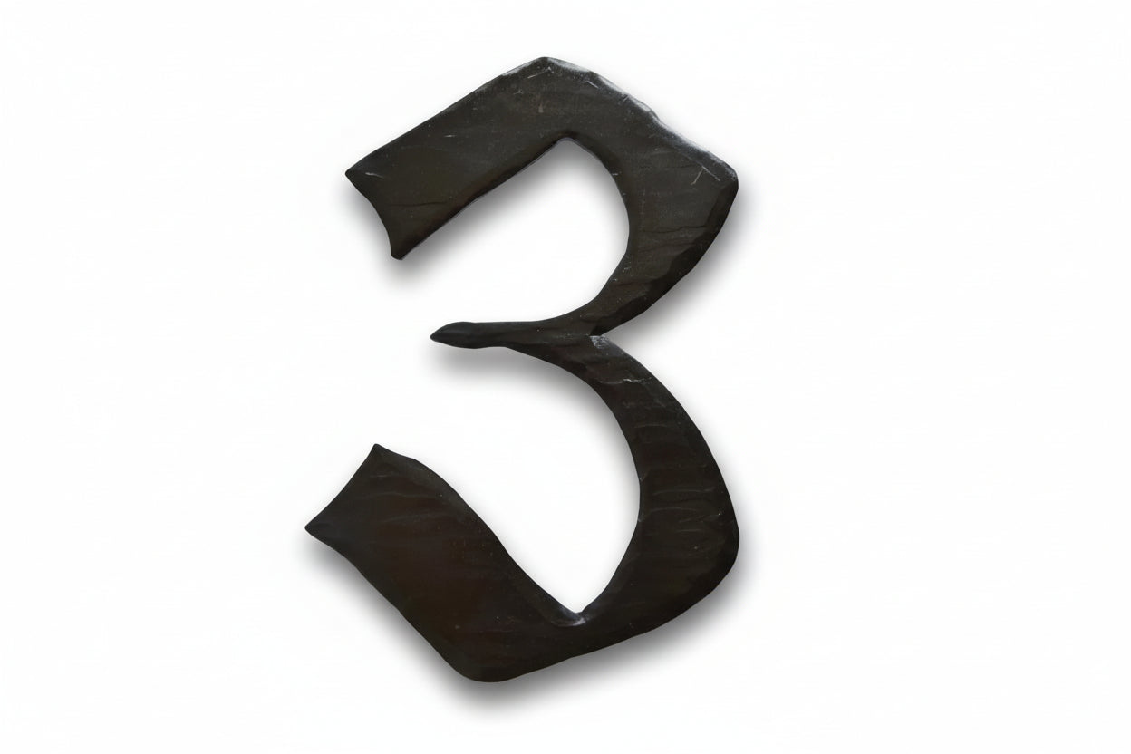 a pair of black scissors sitting on top of a table 