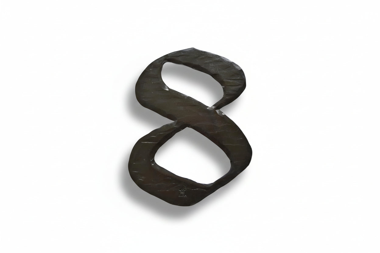 a pair of black scissors sitting on top of a white surface 